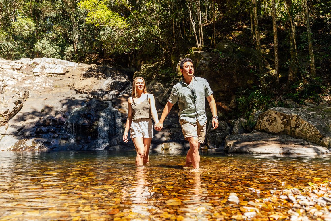 A couple walking through a creek