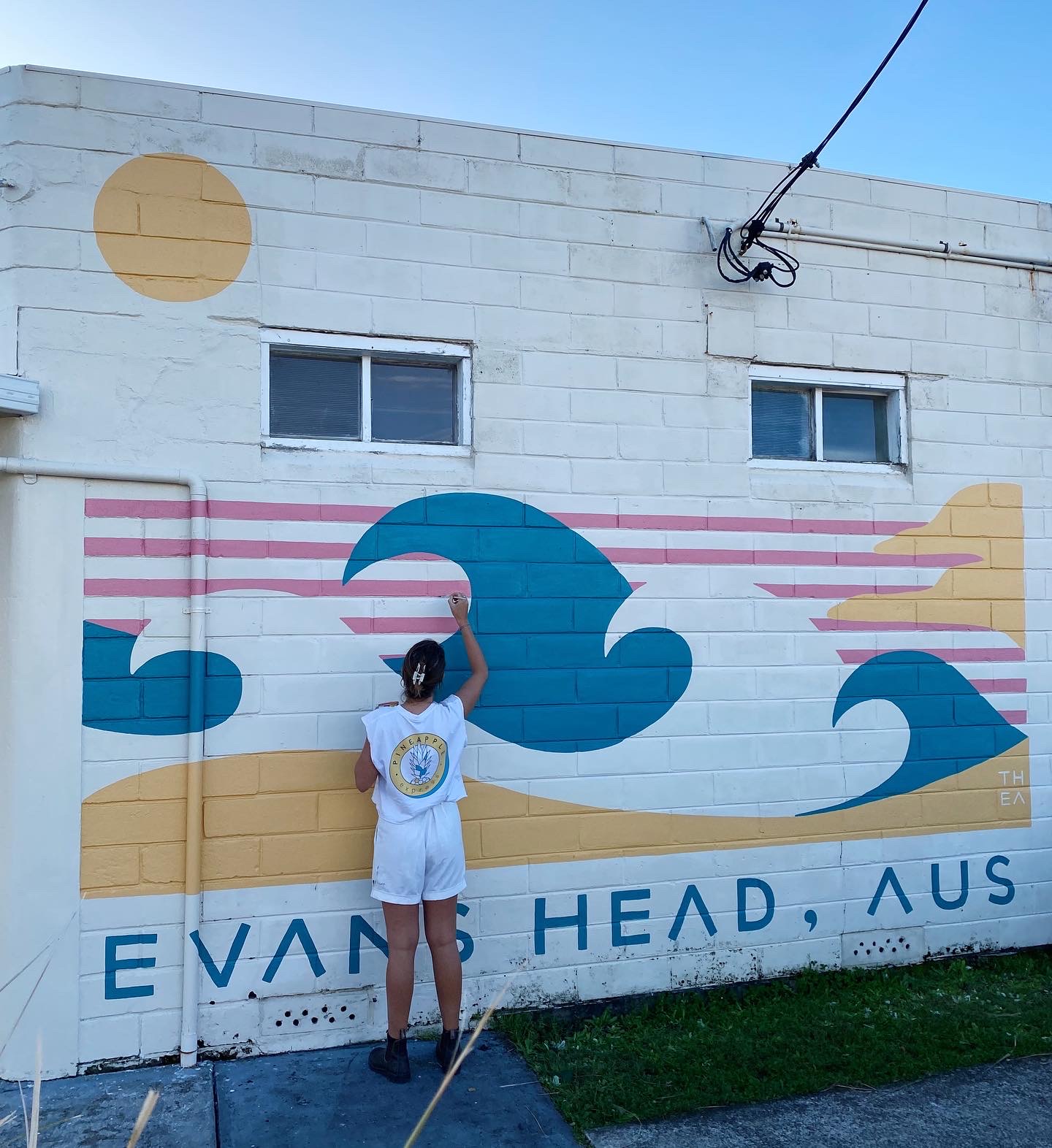 Gold Coast artist Thea Skelsey working on a previous mural